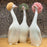 Goossiping Geese Figurine <br> 
Orange and Green <br>
(L 8 x W 11 x H 21) cm